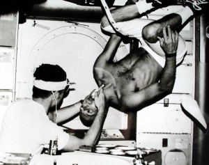 Conrad getting dental checkup from Dr Kerwin (Aboard Skylab). Image Credit: NASA
